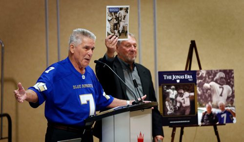 WAYNE GLOWACKI / WINNIPEG FREE PRESS

At left, former Winnipeg Blue Bombers QB Don Jonas at a news conference Friday as friend and former broadcaster Peter Young holds up a 1974 photograph of Jonas shining the shoes of former Prime Minister Pierre Trudeau for a Shinerama fundraiser. The news conference  was held in the Canad Inns Destination Centre Polo Park. Mike McIntyre story Oct.6