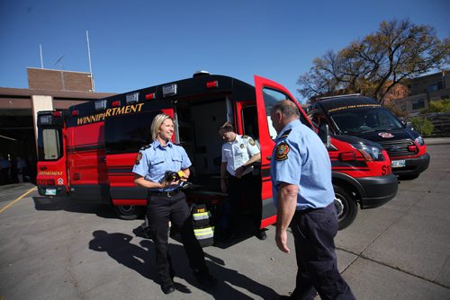 RUTH BONNEVILLE / WINNIPEG FREE PRESS

 Deputy Chief  &#8206;Winnipeg Fire Paramedic Service Tom Wallace, (white shirt), with other WFPS employees look over the new Fire Trucks that were unveiled to the media at the The Ellen Street - Firehall No.1 Friday.  
Various photos both outside and inside the new, compact vehicles.  

Oct 05, 2017