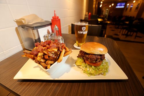 TREVOR HAGAN / WINNIPEG FREE PRESS
Bacon Poutine and the Winnipegger Burger at the Tipsy Cow, restaurant review, Friday, October 6, 2017.