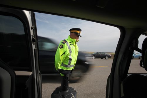 RUTH BONNEVILLE / WINNIPEG FREE PRESS

RCMP set up simulation event for the media on Rosser Road on Thursday  to address the issue of safely when motorists are passing officers.   A mannequin dressed as a RCMP officer stood next to a vehicle pulled over on a highway illustrating what motorist should and should not do when passing.  Motorist must slow down and change lanes when passing to avoid injury or death to officers.  

 Inspector Ed Moreland, Officer in Charge of Traffic Services, spoke about the risk to emergency personnel when motorists do not take the proper precautions when passing emergency vehicles on the side of the road.

Photo of vehicle not slowing down and not changing lanes.  

See media release for details.  

Standup 
Oct 12,, 2017