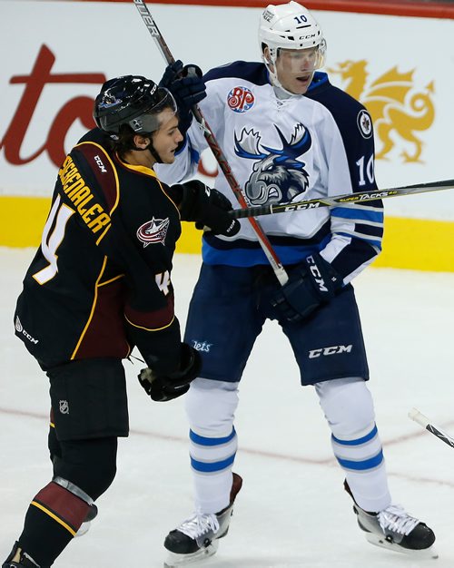 JOHN WOODS / WINNIPEG FREE PRESS
Manitoba Moose Buddy Robinson (10) and Cleveland Monsters' Blake Siebenaler (4) collide during second period AHL action in Winnipeg on Sunday, October 15, 2017.