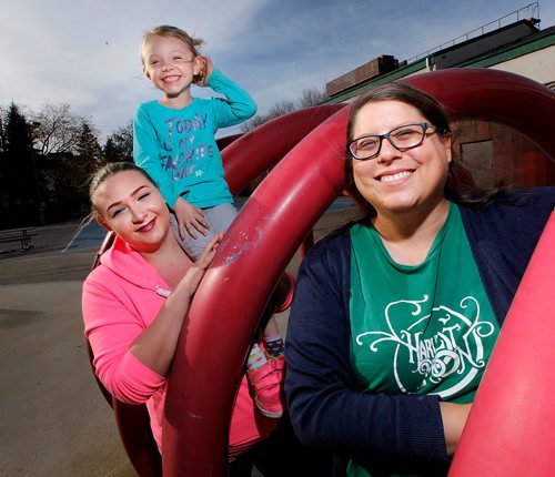 PHIL HOSSACK / WINNIPEG FREE PRESS  - FAith Naylor (left) and her daughter Hailey (6), pose with Allison Besel (Program co-ordinator at a United Way program offering Spence Neighborhood kids safe, constructive afdter school activity in the Magnus Eliason Rec Centre. Faith is the first parent who was actually a child attendee in the program)  - October 17, 2017