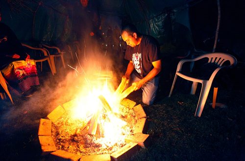 PHIL HOSSACK / WINNIPEG FREE PRESS  -  FirekeeperKirby Nelson keeps the flame burning Tuesday night at the Forks for the Murdered and Missing Aborigional Commision hearings. See Melissa Martin story.  - Oct 17, 2017