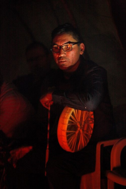 PHIL HOSSACK / WINNIPEG FREE PRESS  -  Firekeeper Jason Parenteau leans on his drum whith the ceeremonial fire reflecting in his glasses Tuesday night at the Forks for the Murdered and Missing Aborigional Commision hearings. See Melissa Martin story.  - Oct 17, 2017