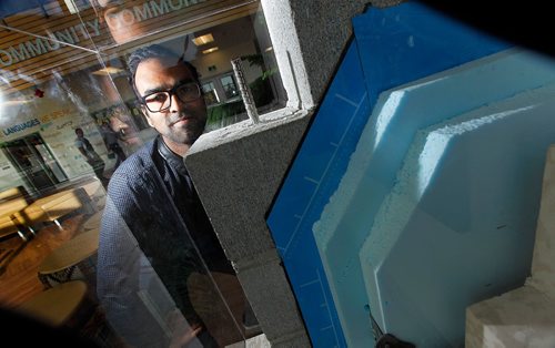 PHIL HOSSACK / WINNIPEG FREE PRESS  -  Grade 5 teacher Shivram Raveendabrose poses with a disply illustrating the energy efficient walls at Amber Trails Community School. The school is the "Geenest" in Canada. See story.  - Oct 18, 2017