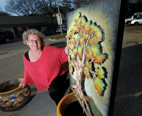 PHIL HOSSACK / WINNIPEG FREE PRESS  -  Susan Smandych poses in the Portage Ave parking lot beside her "La Bodega" shop with some of the art displayed and sold on the lot and in the store. Dave Sanderson's story. SUNDAY SPECIAL  - Oct 19, 2017