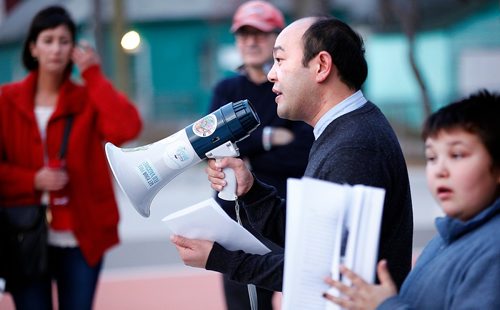 PHIL HOSSACK / WINNIPEG FREE PRESS  -  Jason Syvixay uses a megaphone to deliver his message at the weekly gathering at the Bell. The public was invited to The Bell Tower, Selkirk Ave. and Powers St., at 6 p.m. today for a report highlighting the work of Meet Me at The Bell Tower and recommendations for planners when protest erupts in public spaces. Jason Syvixay, a master of city planning graduate student from the University of Manitoba, undertook the research. This will be a stdup with an extended cutline Scott Gibbons is writing. - Oct 20, 2017