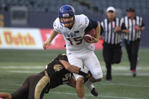RUTH BONNEVILLE / WINNIPEG FREE PRESS

Sports 
UBC Quarterback 
#15 Michael O'Connor gets taken down by Bisons #47 James Mau during the 2nd half of play at Investors Group Field Saturday.  
University of British Columbia team won the game against the Bisons  with a score of 17-16.  
 
Oct 21,, 2017
