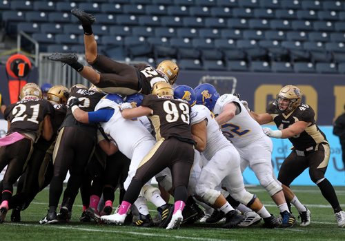 RUTH BONNEVILLE / WINNIPEG FREE PRESS

Sports 
Bisons players try and get some yards after contact during game against UBC at  Investors Group Field Saturday.  
University of British Columbia team won the game against U of M Bisons with a score of 17-16.  
 
Oct 21,, 2017