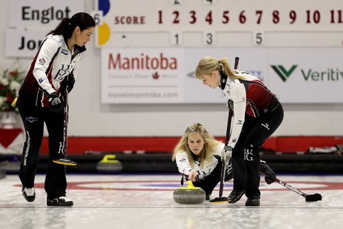 TREVOR HAGAN / WINNIPEG FREE PRESS
Jennifer Jones throws her shot as Jill Officer and Dawn McEwen sweep, while playing against the Englot rink at the curling club in Portage la Prairie, Sunday, October 22, 2017.