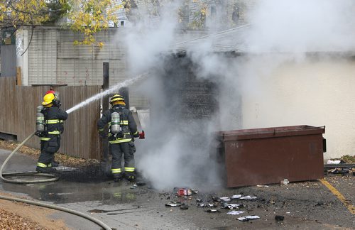 JASON HALSTEAD / WINNIPEG FREE PRESS

Firefighters work at the scene of a mattress/garage fire about 1:45 p.m. in the west backlane of the 100-block of Furby Street on Oct. 24, 2017.
