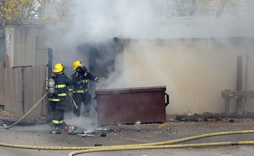 JASON HALSTEAD / WINNIPEG FREE PRESS

Firefighters work at the scene of a mattress/garage fire about 1:45 p.m. in the west backlane of the 100-block of Furby Street on Oct. 24, 2017.
