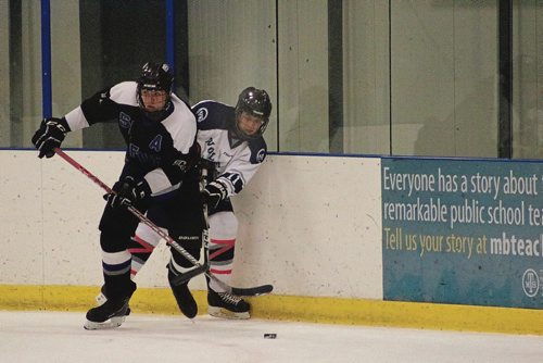 Canstar Community News Oct. 18, 2017 - Wolverines Mathew Sikora fights for the puck at a game against the Sanford Sabres. (LIGIA BRAIDOTTI/CANSTAR COMMUNITY NEWS/TIMES)