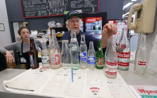 JASON HALSTEAD / WINNIPEG FREE PRESS

Larry Brown, owner of Oscar's Deli, with his collection of old pop bottles at the Hargrave Street deli on Oct. 24, 2017.
(Re: INTERSECTION - old restos)
