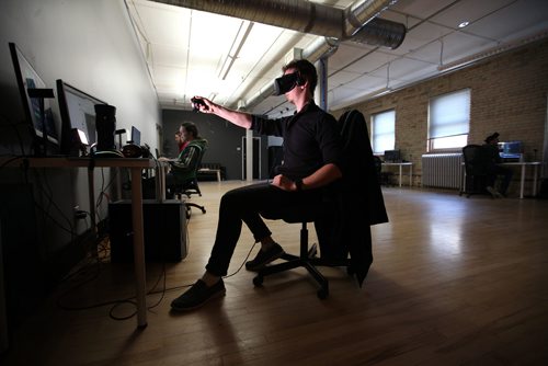 RUTH BONNEVILLE / WINNIPEG FREE PRESS

49.8 Feature
WORKPLACE #5 - Campfire Union 
This up-and-coming virtual reality design company is keeping workplace culture top of mind by prioritizing social time among co-workers. 
One of their staff members play tests the mechanics.of a virtual reality program at office on McDermot Ave.
 See Jessica's story. 

Oct 24,, 2017