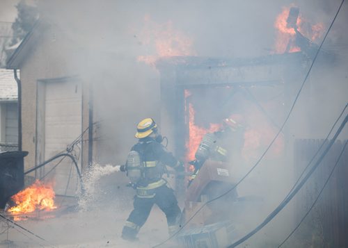 MIKE DEAL / WINNIPEG FREE PRESS
WFPS crews work on putting out a garage fire in the 600 block of Church Avenue Thursday afternoon.
171026 - Thursday, October 26, 2017.