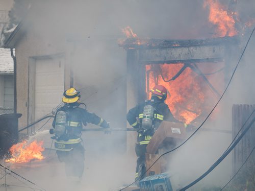 MIKE DEAL / WINNIPEG FREE PRESS
WFPS crews work on putting out a garage fire in the 600 block of Church Avenue Thursday afternoon.
171026 - Thursday, October 26, 2017.