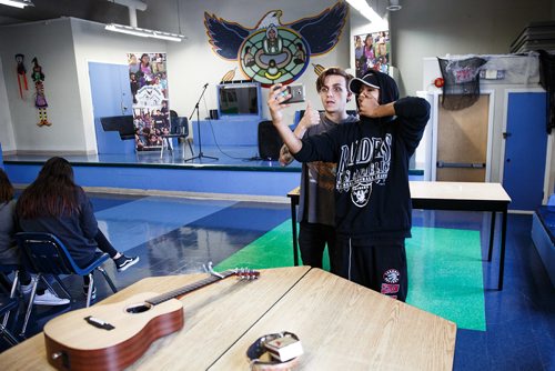 MIKE DEAL / WINNIPEG FREE PRESS
Raoul Harper (right) takes a selfie with Scott Helman, Juno 2016 nominationed artist  (Breakthrough Artist of the Year and Pop Album of the Year) after a performance for students in Eagles Circle School at Rossbrook House as part of United Way Winnipegs Koats for Kids program Monday morning.
171030 - Monday, October 30, 2017.
