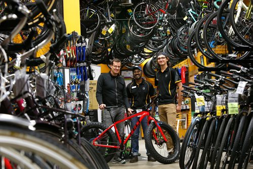 WAYNE GLOWACKI / WINNIPEG FREE PRESS

49.8 From left, Tim Woodcock, owner of Woodcock Cycle with sales associates Jude Gunasekera and Kelsey Unger.    Jessica Urbanski story Oct.31 2017