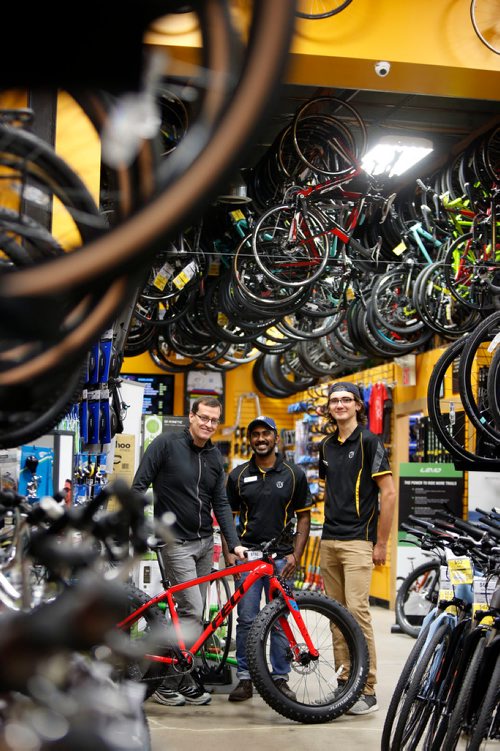 WAYNE GLOWACKI / WINNIPEG FREE PRESS

49.8 From left, Tim Woodcock, owner of Woodcock Cycle with sales associates Jude Gunasekera and Kelsey Unger.    Jessica Urbanski story Oct.31 2017