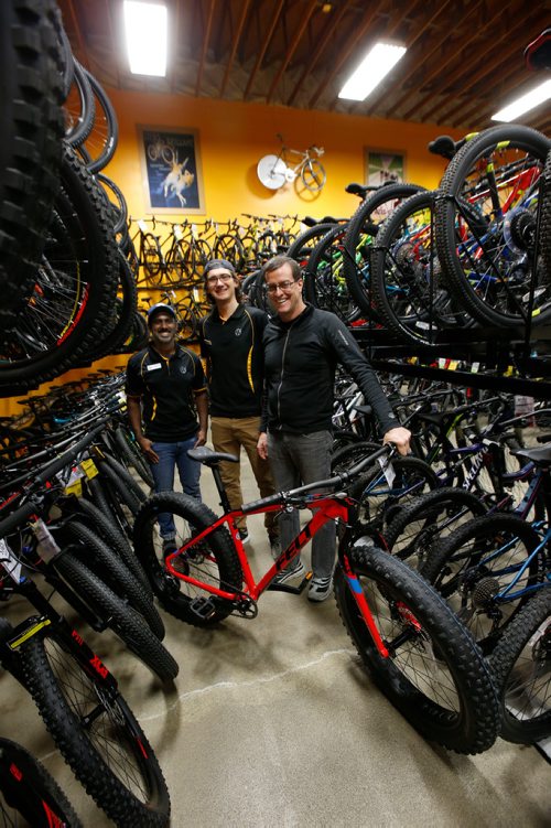 WAYNE GLOWACKI / WINNIPEG FREE PRESS

49.8 From right, Tim Woodcock, owner of Woodcock Cycle with sales associates Kelsey Unger and Jude Gunasekera .    Jessica Urbanski story Oct.31 2017