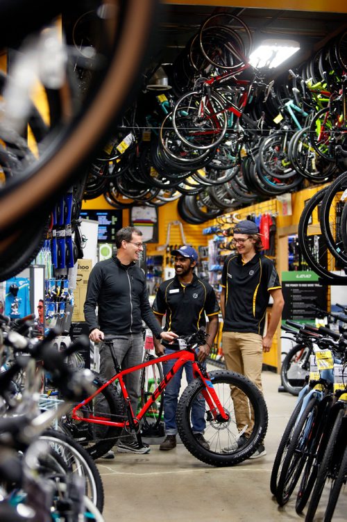 WAYNE GLOWACKI / WINNIPEG FREE PRESS

49.8 From left, Tim Woodcock, owner of Woodcock Cycle with sales associates Jude Gunasekera and Kelsey Unger.    Jessica Urbanski story Oct.31 2017