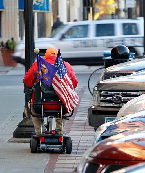 PHIL HOSSACK / WINNIPEG FREE PRESS  -  A Fargo resident makes his way down broadway ave flying the stars and stripes and a Viking's flag on Tuesday. See Melissa Martin feature. - Oct 24, 2017