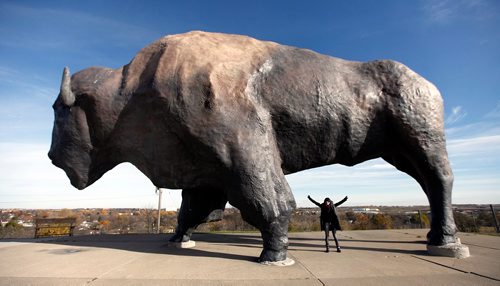 PHIL HOSSACK / WINNIPEG FREE PRESS  -  Melissa Martin poses under the girth of the "World's Largest Buffalo" at Jamestown's Frontier Village. See Melissa Martin feature. - Oct 24, 2017
