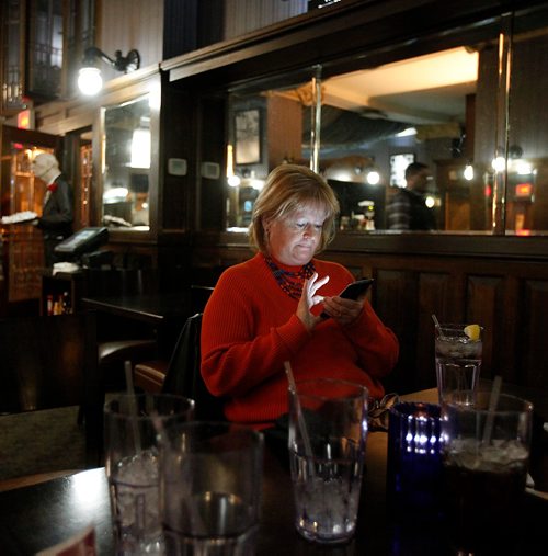 PHIL HOSSACK / WINNIPEG FREE PRESS  - Janet Michelson checks her phone in a downtown Bismark eatery. See Melissa Martin feature. - Oct 25, 2017