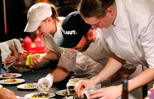 PHIL HOSSACK / WINNIPEG FREE PRESS  - Workers prep plates at Sous Sol, Chef Mike Robins table at the Gold Medal Plates event Wednesday evening at the RBC Convention Centre. See release. - November 1, 2017