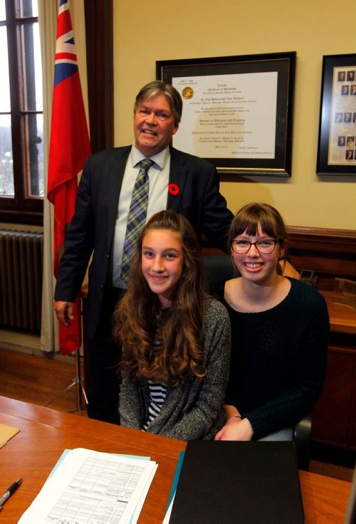 BORIS MINKEVICH / WINNIPEG FREE PRESS
Take Our Kids to Work Day  - From left, Minister of Education and Training Ian Wishart poses for a photo with grade 9 students Clara Gibbons and Nadia Minkevich in his office after being interviewed by them. Nov. 1, 2017