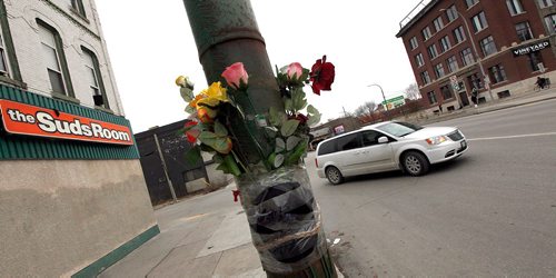 PHIL HOSSACK / WINNIPEG FREE PRESS  - A memorial bouquet along with the victim's cap and a braid of sweetgrass mark the spot where an off duty police officer struck and killed a pedestrian at Sutherland on Main. See Gord Sinclair's story. - November 2, 2017
