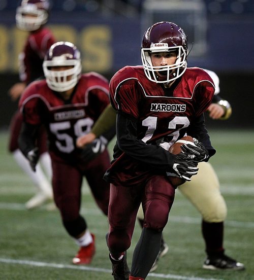 PHIL HOSSACK / WINNIPEG FREE PRESS  - Daniel McIntyre Maroon #13 Ethan Schnerch consolidates his grip on the ball as he manouvers for running room  in playoff action at Investor's Group Field Thursday evening . - November 2, 2017