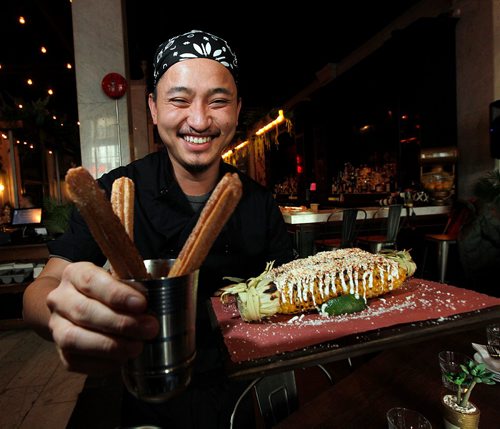 PHIL HOSSACK / WINNIPEG FREE PRESS  - Chef Tommy Nguyen shows off Churros (left) and street corn at La Carnita.  See review. - November 3, 2017