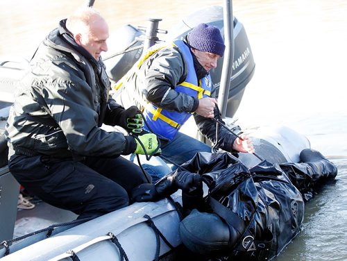 PHIL HOSSACK / WINNIPEG FREE PRESS  - Recuers roll a hypothermic victim into a police zodiac friday afternoon as part of a hypothermia rescue program offered to RCMP and WPS members, see release.The "victim" was well insulated and warm inside a dry suit for the demonstration. - November 3, 2017

LOCAL STDUP - water rescue training

PROFESSOR POPSICLE TEACHING RCMP, WPS MEMBERS BEYOND COLD WATER BOOT CAMP

Cold water rescue demonstrations Friday afternoon in the Red River 


University of Manitoba Faculty of Kinesiology Professor Gordon Giesbrecht is known better by his nickname Professor Popsicle, thanks to his renowned research and teaching on the effects of cold water on the body. This fall, he published his 100th paper in a peer reviewed journal on the topic.



Dr Giesbrecht has offered a Beyond Cold Water Boot Camp across Canada to members of the lifesaving community for the past number of years, and for the first time this week, hes offering it in Winnipeg.



30 enrollees from the Winnipeg Police Service, RCMP, Red Cross and the Lifesaving Society attended day one of the course yesterday, and will continue their training today (Friday, November 3, 2017).



The two-day course includes classroom work in the morning and rescue training in the Red River in the afternoon, with RCMP boats and victims in the water being rescued and treated on shore.



Were training emergency responders including law enforcement personnel, search and rescue members, and other educators about the dangers of cold water immersion and how to rescue and treat people who are in cold water, said Giesbrecht. Were demonstrating different types of emergency gear, and weve got three RCMP boats helping us simulate real rescue situations.


One of the things were working on is exploding some of the myths around what really are dangers of cold water immersion and how to safely extract someone from the cold. And despite some popular opinion, were sh