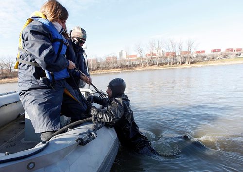 PHIL HOSSACK / WINNIPEG FREE PRESS  - Recuers haul a hypothermic victim into a police zodiac friday afternoon as part of a hypothermia rescue program offered to RCMP and WPS members, see release.The "victim" was well insulated and warm inside a dry suit for the demonstration. - November 3, 2017

LOCAL STDUP - water rescue training

PROFESSOR POPSICLE TEACHING RCMP, WPS MEMBERS BEYOND COLD WATER BOOT CAMP

Cold water rescue demonstrations Friday afternoon in the Red River 


University of Manitoba Faculty of Kinesiology Professor Gordon Giesbrecht is known better by his nickname Professor Popsicle, thanks to his renowned research and teaching on the effects of cold water on the body. This fall, he published his 100th paper in a peer reviewed journal on the topic.



Dr Giesbrecht has offered a Beyond Cold Water Boot Camp across Canada to members of the lifesaving community for the past number of years, and for the first time this week, hes offering it in Winnipeg.



30 enrollees from the Winnipeg Police Service, RCMP, Red Cross and the Lifesaving Society attended day one of the course yesterday, and will continue their training today (Friday, November 3, 2017).



The two-day course includes classroom work in the morning and rescue training in the Red River in the afternoon, with RCMP boats and victims in the water being rescued and treated on shore.



Were training emergency responders including law enforcement personnel, search and rescue members, and other educators about the dangers of cold water immersion and how to rescue and treat people who are in cold water, said Giesbrecht. Were demonstrating different types of emergency gear, and weve got three RCMP boats helping us simulate real rescue situations.


One of the things were working on is exploding some of the myths around what really are dangers of cold water immersion and how to safely extract someone from the cold. And despite some popular opinion, were sh