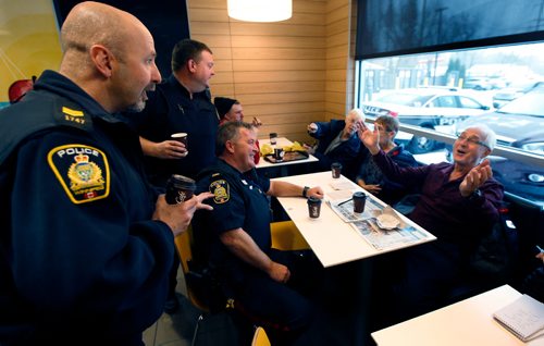 WAYNE GLOWACKI / WINNIPEG FREE PRESS

At right, Dennis Stokotelny and his wife Virginia chat with Winnipeg Police officers from left, Patrol Sgt. Phil Penner, Const. Sean Donovan and Const. Brad Sparrow at the Coffee with a Cop event Saturday held at McDonalds at 2475 Portage Ave. The informal gathering is a chance for residents to ask questions, voice concerns, and get to know the officers in their neighbourhood.  Alex Paul story   Nov. 4 2017