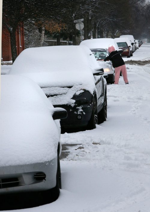 WAYNE GLOWACKI / WINNIPEG FREE PRESS

A motorist clears the snow off her car parked on College Ave. Saturday afternoon. ( She didnt want to give me her name.)  For weather story. Nov. 4 2017
