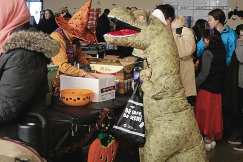 Canstar Community News Oct. 31, 2017 - A little boy dresses up as a dinossaur to get candy at the Indian and Metis Friendship Centres Safe Halloween. (LIGIA BRAIDOTTI/CANSTAR COMMUNITY NEWS/TIMES)