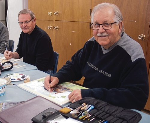 Canstar Community News Fred Perchaluk (right), past president of the Local Colour Art Group, works on a watercolour painting of Dalnavert House for the upcoming Local Colour Art Group Annual Exhibit and Sale as Jerry Magnusson (left) takes a break from his painting of the St. Boniface Cathedral to take a look. (SHELDON BIRNIE/CANSTAR/THE HERALD)