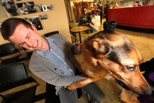 PHIL HOSSACK / WINNIPEG FREE PRESS  - Humane Society's Kyle Jahns endures the affection of "King" a Shepherd cross who was on the operating table when alarms sounded and the Humane Society was evacuated due to a flood Monday. The Society will open it's doors again Wednesday after cleaning up the water logged office and reception area........See Alex Paul story.  - November 7, 2017