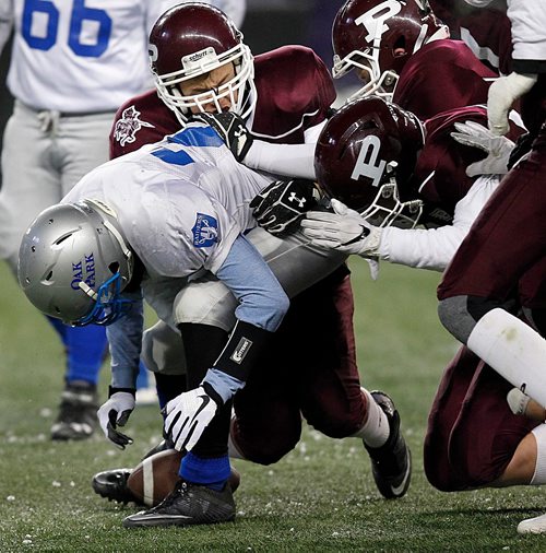 PHIL HOSSACK / WINNIPEG FREE PRESS  - Oak Park JV Raider running back  #27 Devlin Kilmister looks for the fumble in his feet as he goes down St Paul's maroon defence. Oak Park took over the ball. at the Investor's Group Field Tuesday.  - November 7, 2017