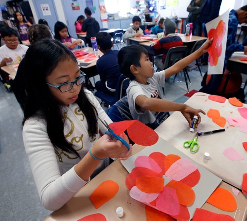 WAYNE GLOWACKI / WINNIPEG FREE PRESS 

At left, Danaca,10 and Thyron,9, work on their their poppies during art class at Tyndall Park Community School Thursday to mark Remembrance Day this weekend. All through the school hallways displayed the  students Remembrance Day art work that included poppies, cemeteries and battle scenes.   Nov. 9 2017