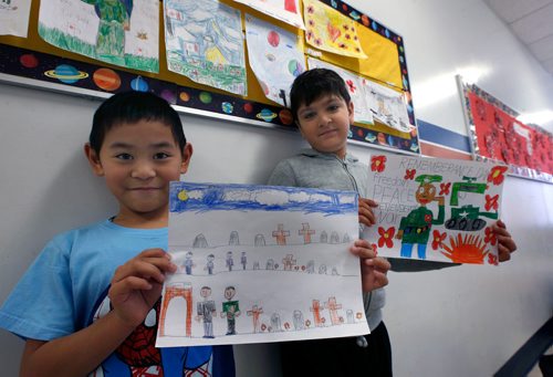 WAYNE GLOWACKI / WINNIPEG FREE PRESS 

At left, Gerald,7, and Purav,7, with their drawings at Tyndall Park Community School Thursday to mark Remembrance Day this weekend. All through the school, hallways displayed the students Remembrance Day art work that included poppies, cemeteries and battle scenes.   Nov. 9 2017