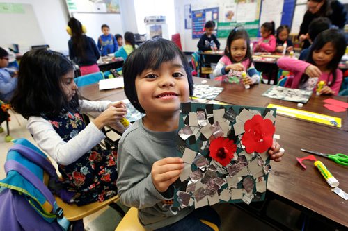 WAYNE GLOWACKI / WINNIPEG FREE PRESS 

Andrae holds up his version of poppies on Flanders Fields during art class at Tyndall Park Community School Thursday to mark Remembrance Day this weekend. All through the school hallways displayed the  students  Remembrance Day art work that included poppies, cemeteries and battle scenes.   Nov. 9 2017