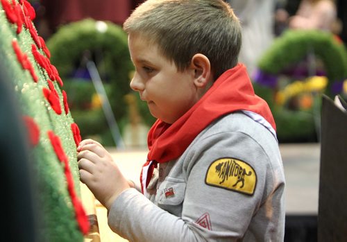 RUTH BONNEVILLE / WINNIPEG FREE PRESS

Alexander Banack-Foster (9yrs) with cubs  pins his poppy on the cenotaph after the annual Winnipeg Remembrance Day Service, at RBC Convention Centre Saturday.  

See Ryan Thorpe story. 

Nov 11, 2017