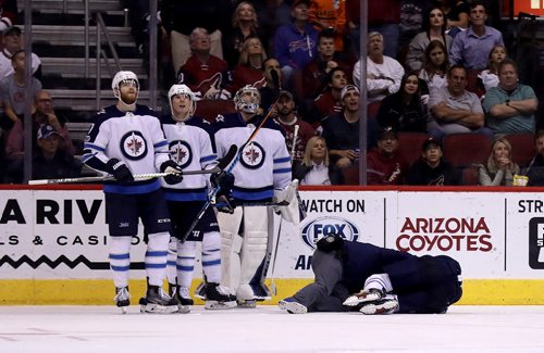 TREVOR HAGAN / WINNIPEG FREE PRESS
Winnipeg Jets' Tyler Myers (57) lays hurt on the ice while playing against the Arizona Coyotes' during third period NHL action, in Glendale Arizona, Saturday, November 11, 2017.