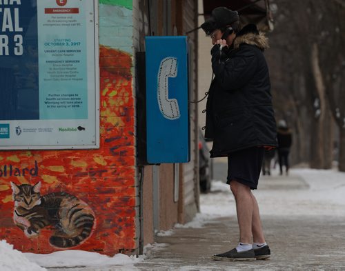 COLIN CORNEAU / WINNIPEG FREE PRESS
Matthew Frost makes a call from a Wolseley Avenue payphone. Frost had inadvertently locked his way out of his nearby apartment and reached out to a friend before the cold got to him. November 12, 2017