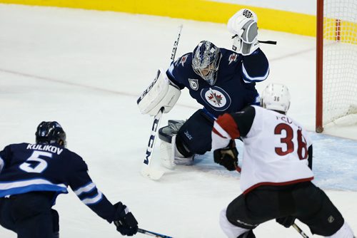 JOHN WOODS / WINNIPEG FREE PRESS
Winnipeg Jets goaltender Connor Hellebuyck (37) saves the shot from Arizona Coyotes' Derek Stepan (21) as Christian Fischer (36) looks for a rebound and Jets' Dmitry Kulikov (5) defends during second period NHL action in Winnipeg on Tuesday, November 14, 2017.