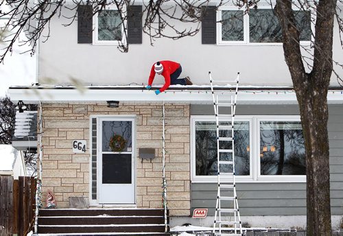 RUTH BONNEVILLE / WINNIPEG FREE PRESS

Kevin Rettit crawls along his 1st floor roof on the overhang of his two-storey house in River Heights Wednesday to finish stringing his Christmas Lights that he started hanging up yesterday.  He just happened to be wearing red which made him look like St. Nick had arrived early;.  

Standup photo


Nov 15, 2017